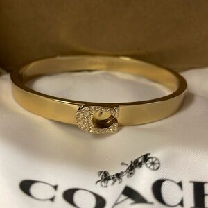 Brand new Gold tone Coach  bangle with pave in the logo.